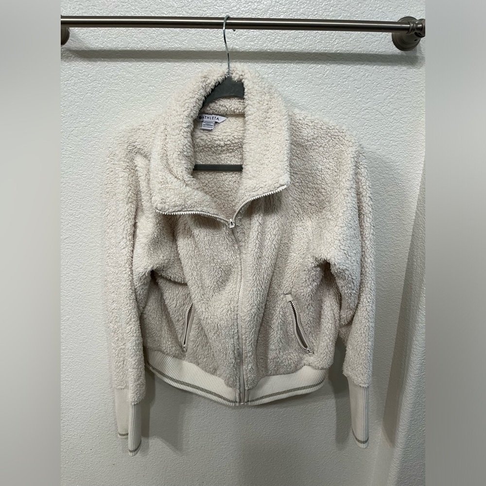Cream colored, fuzzy zip up jacket